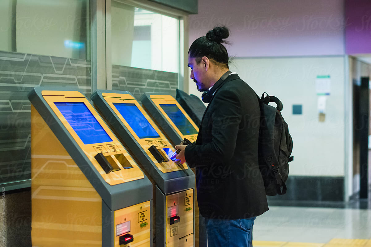 Man buying subway ticket in machine