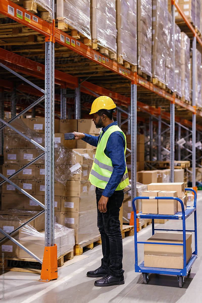 Male worker scanning goods at warehouse