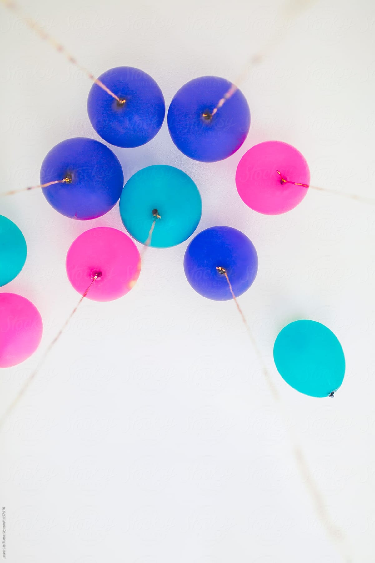 Blue, teal and magenta balloons, with golden cords