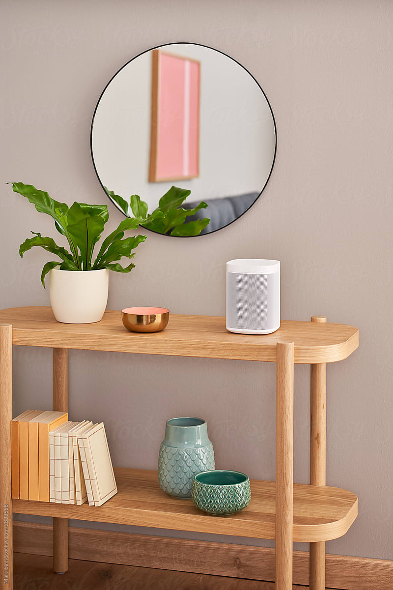 Smart speaker on shelf with decorations and books