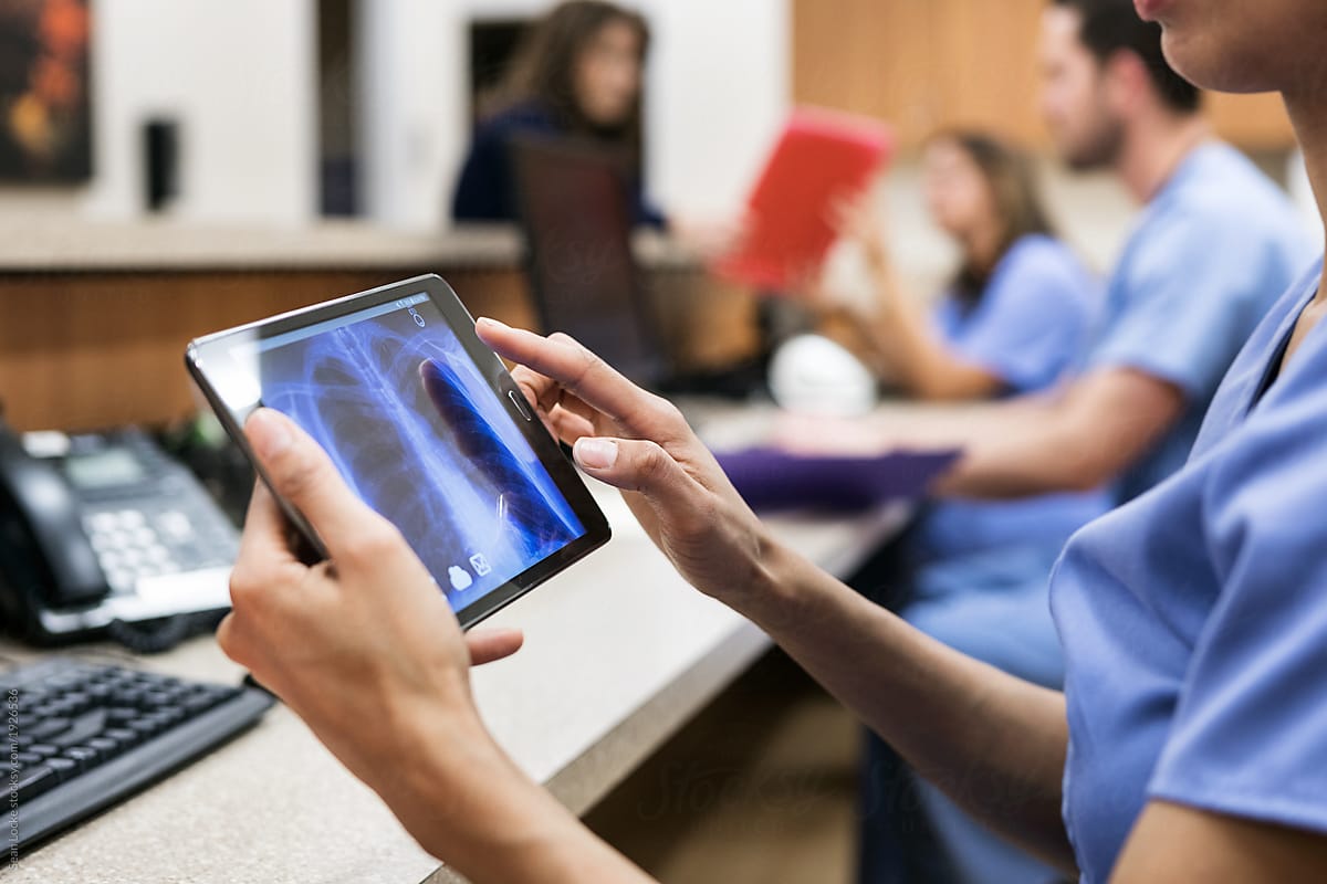 Clinic: Looking At A Patient X-Ray On Tablet