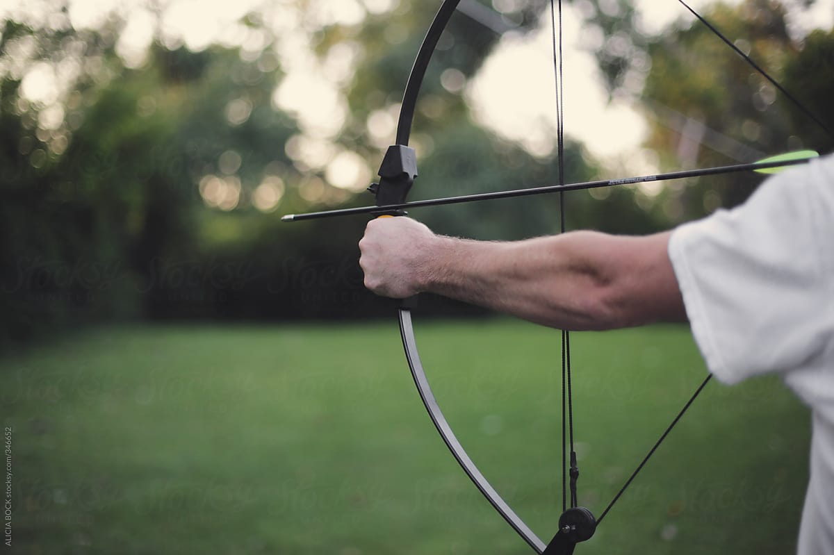 The Arm Of A Man Shooting A Bow And Arrow At A Target On A Summer Evening By Stocksy 5112