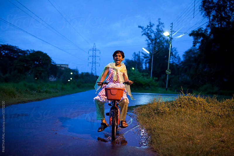 Teenage girl plying and making fun with cycle in blue hour