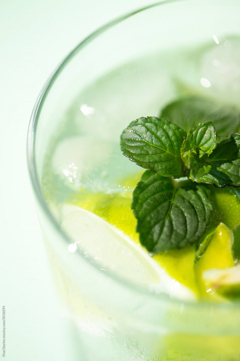 Classic rum mojito cocktail against green background