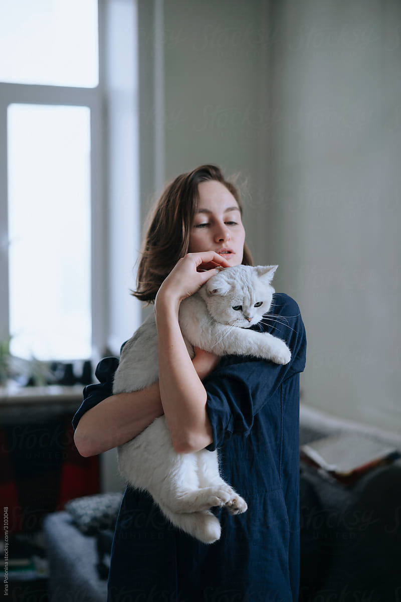 Girl with a white cat.
