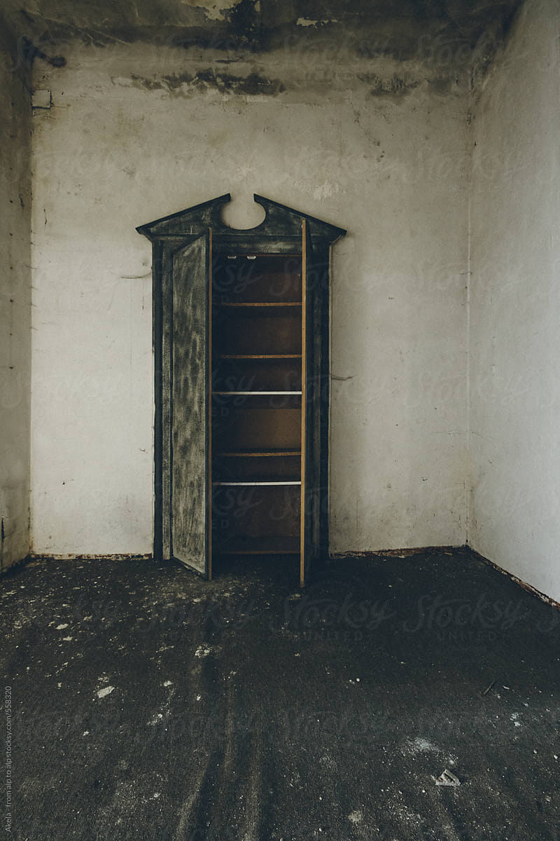 spooky wall cabinet in old abandoned room