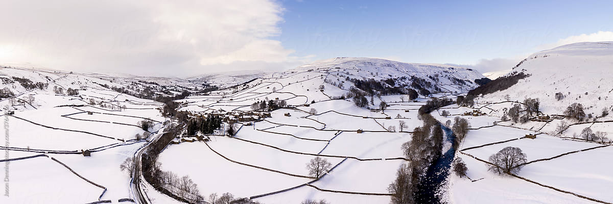 Swaledale Muker and thwaite covered in snow in winter aerial North Yorkshire Dales England