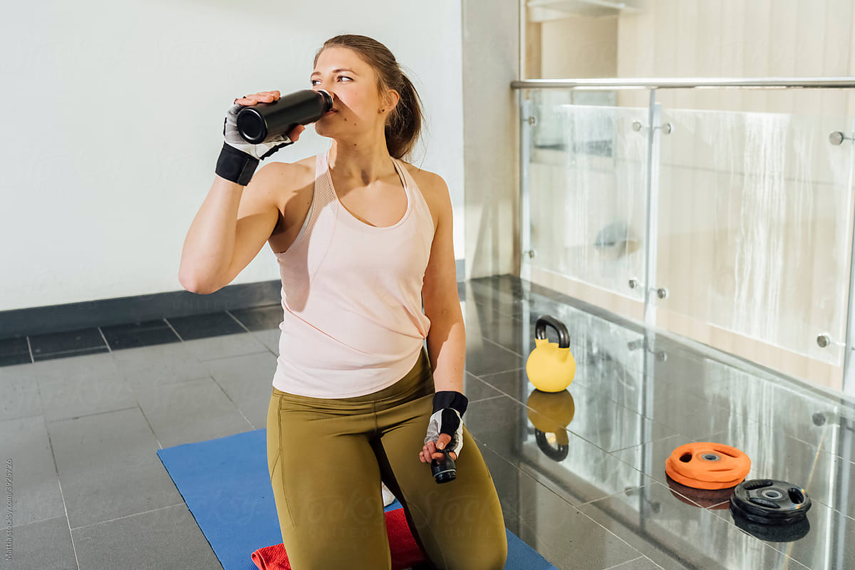 Woman Drinking Water During Her Sport Training
