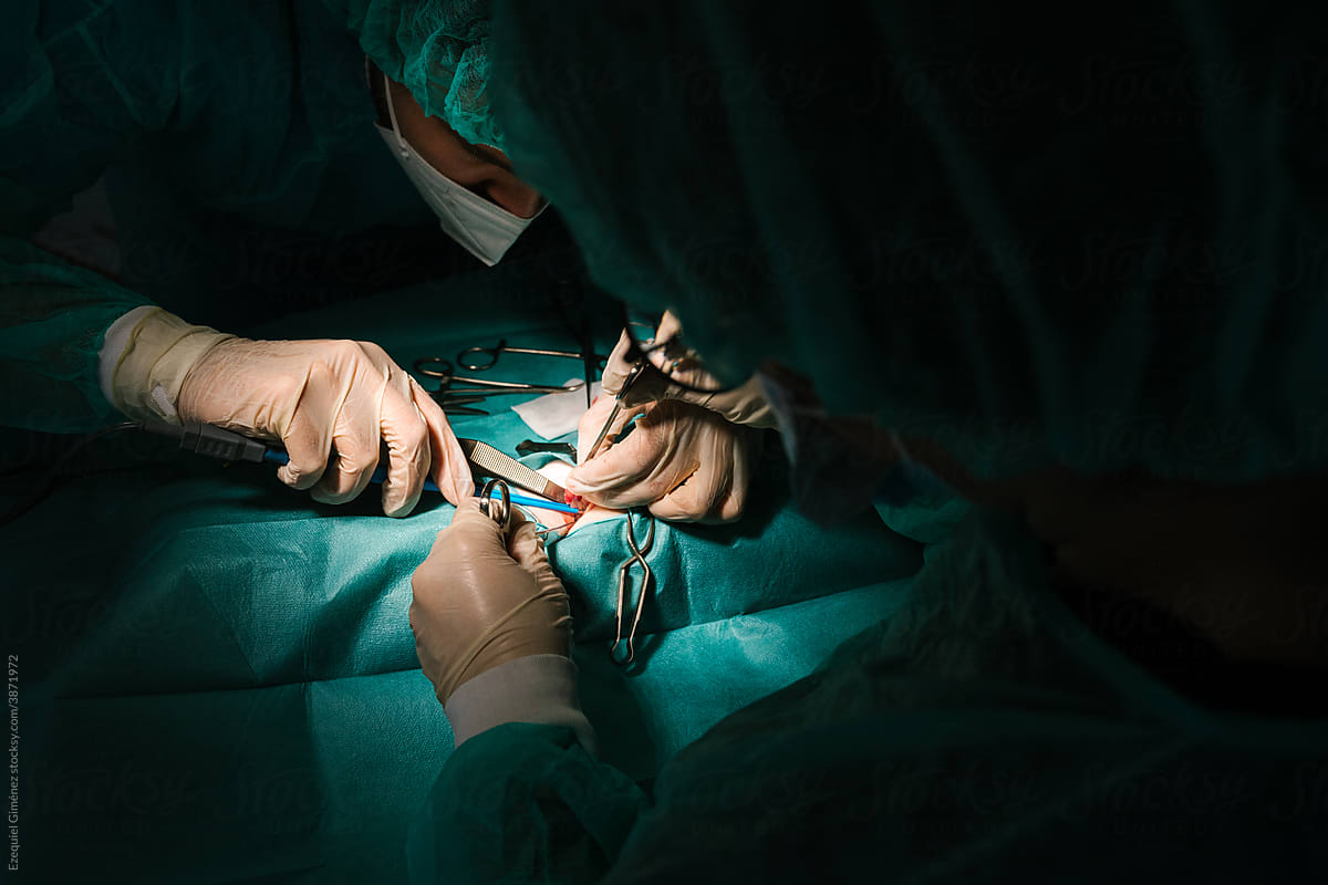 Light focused on the hands of operating surgeons