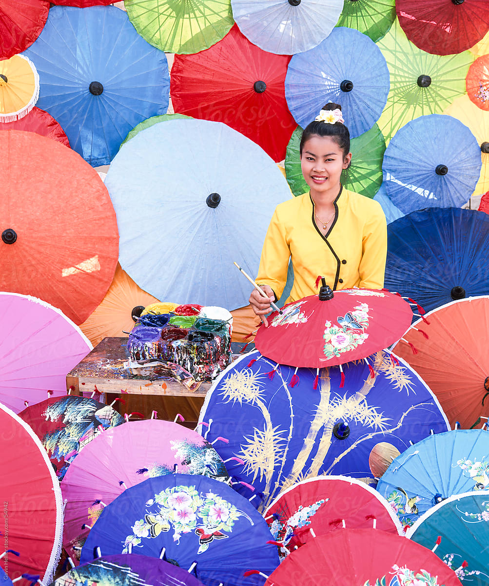 Woman painting umbrellas, Bo Sang umbrella village, Chiang Mai, northern Thailand, Asia