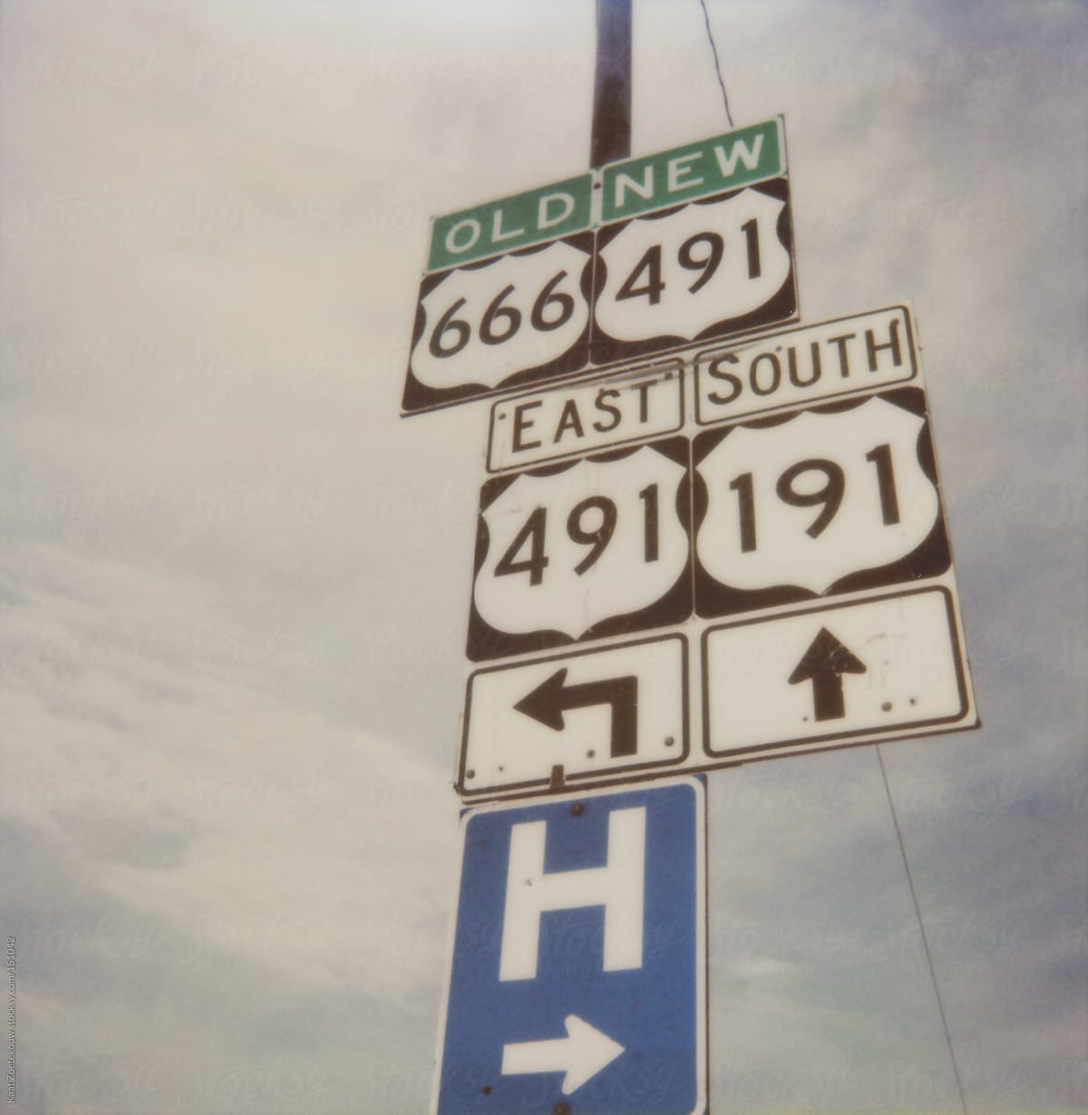 A frameless polaroid of traffic signs indicating a change in routename: route 666 is now route 491