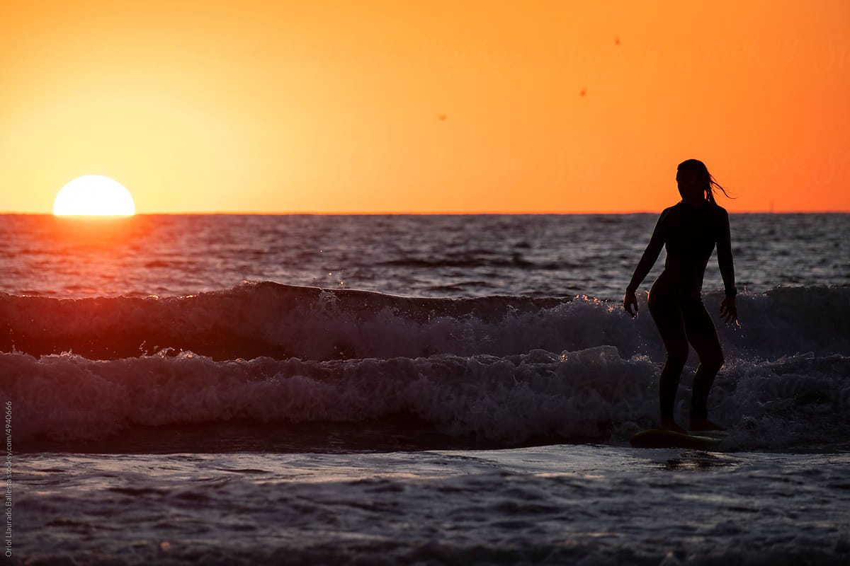 Surfing with a sunset