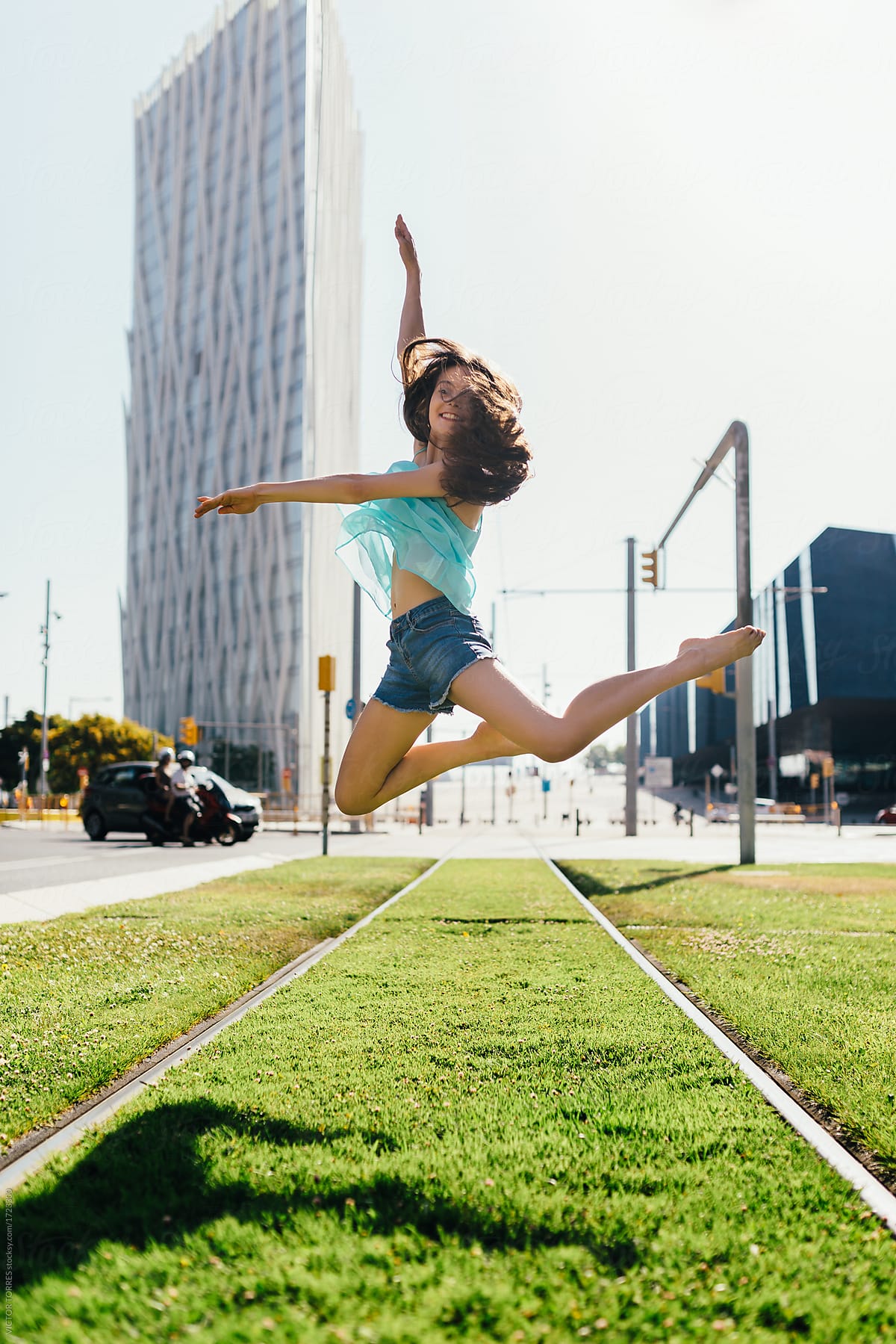 Young dancer jumping on urban background