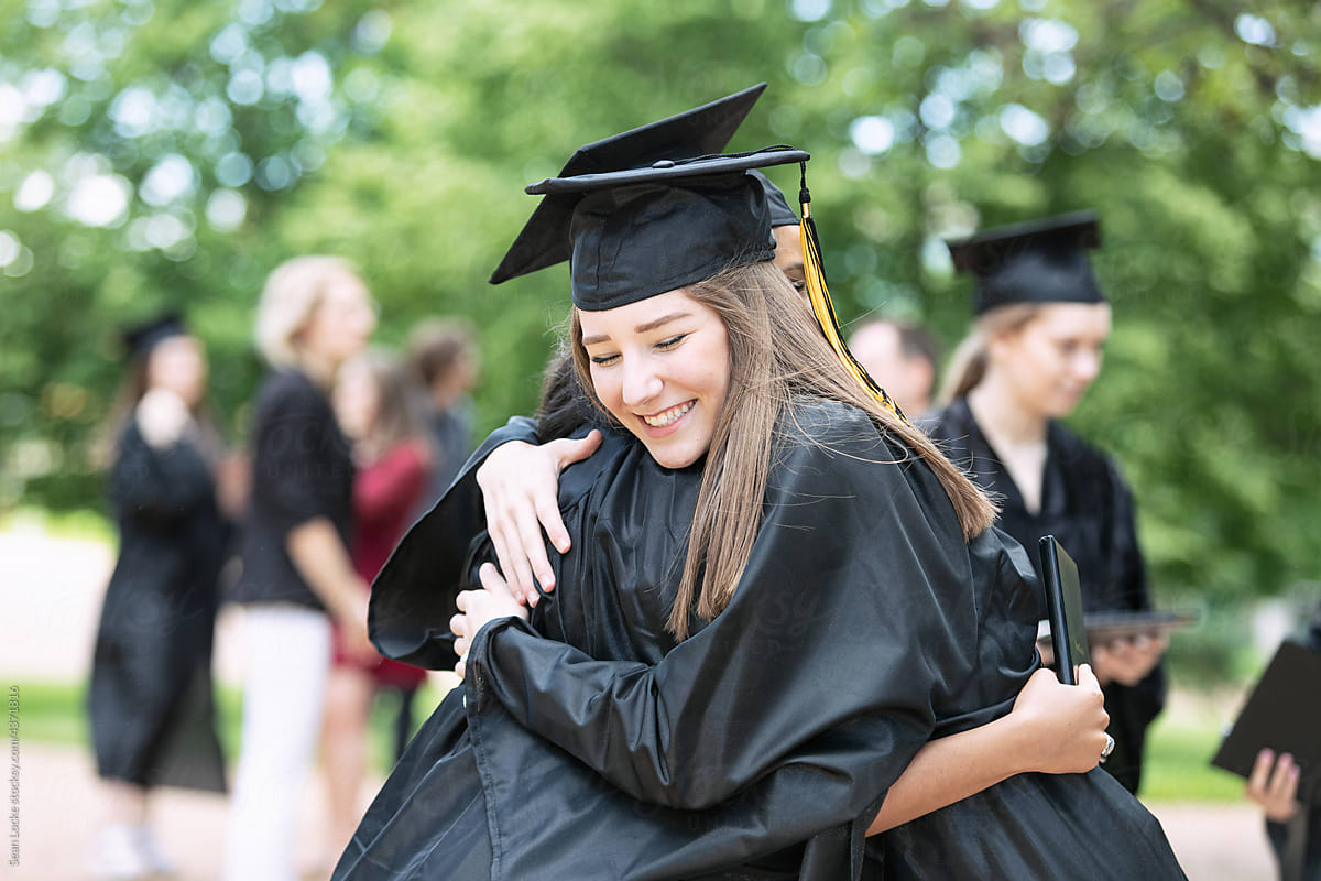 Grad Friends Embrace After Graduating By Stocksy Contributor Sean Locke Stocksy 