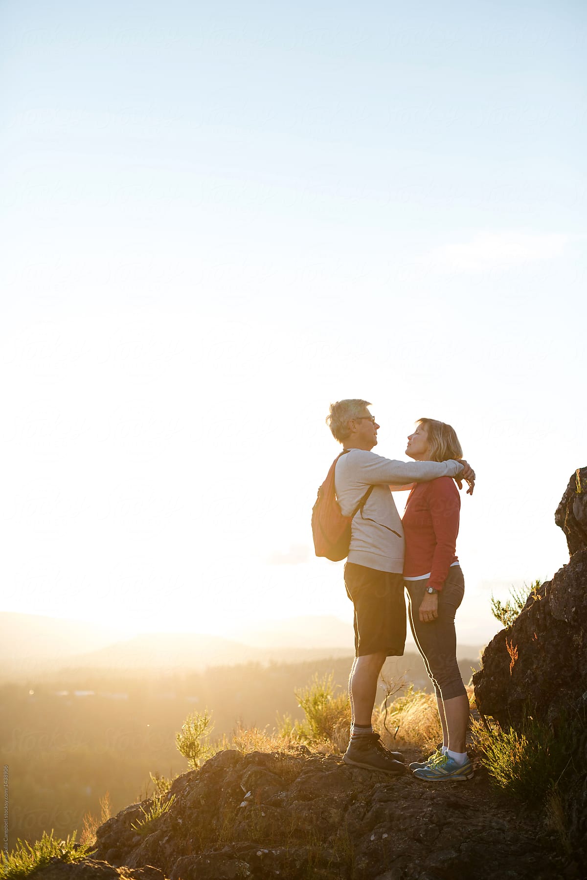 Fit, active middle age couple hiking together at sunset