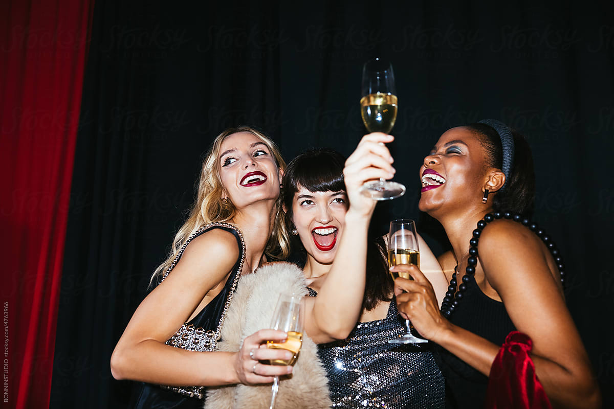 Stylish ladies with champagne glasses celebrating Xmas