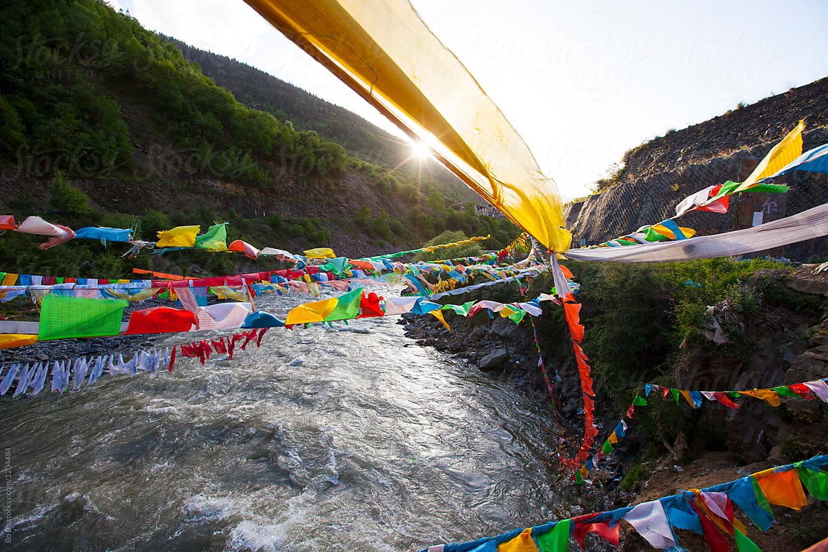 Tibetan Prayers Flags on the River at Sunset