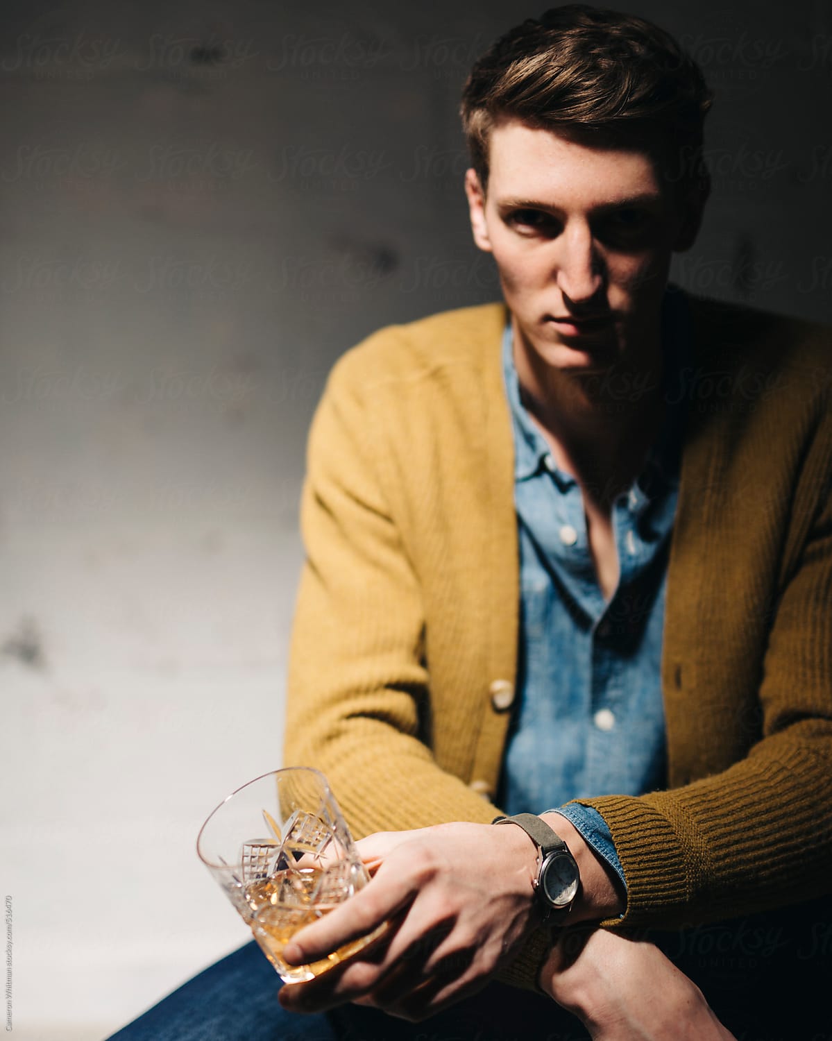 Young man drinking whiskey