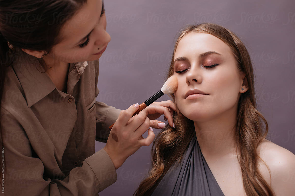 Make up artist working with model