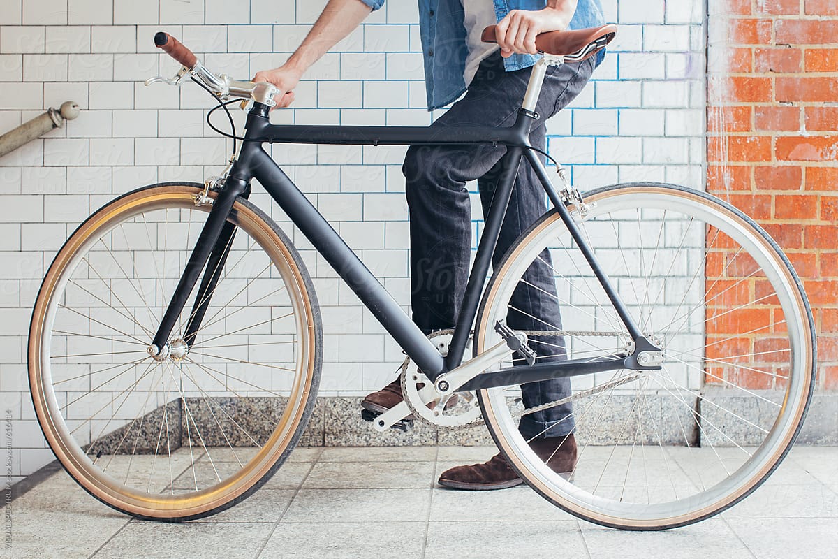 Young Man Standing Behind Minimalist Black Single-Speed Bicycle
