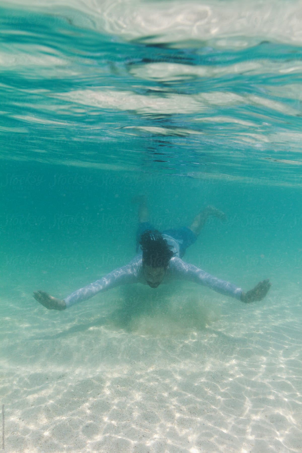 Man swimming underwater in tropical sea