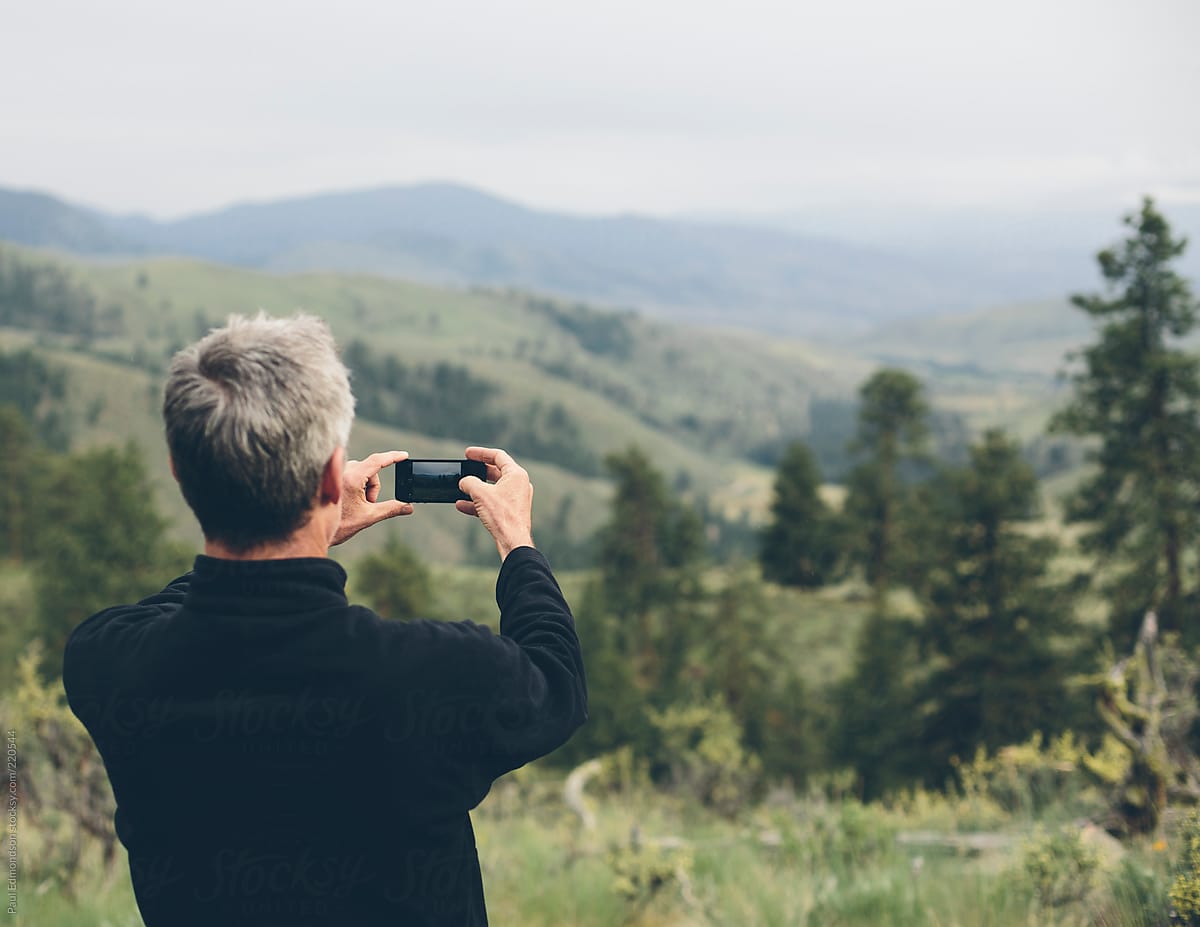 Man taking photographs  with smart phone