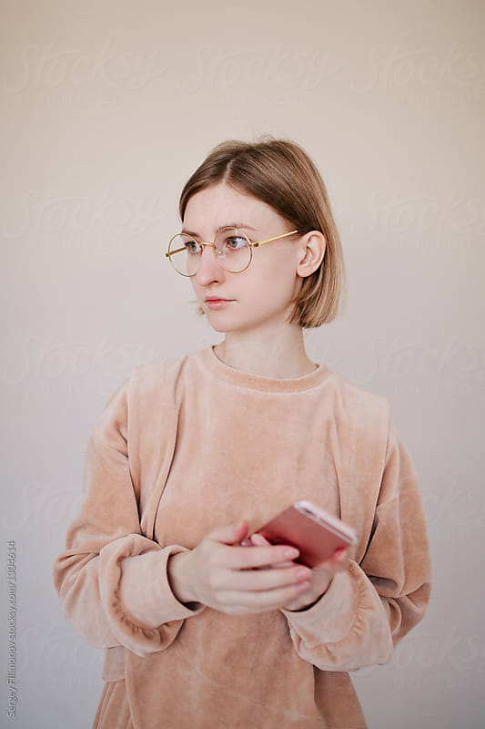 Indoor portrait of attractive young female in nerd glasses