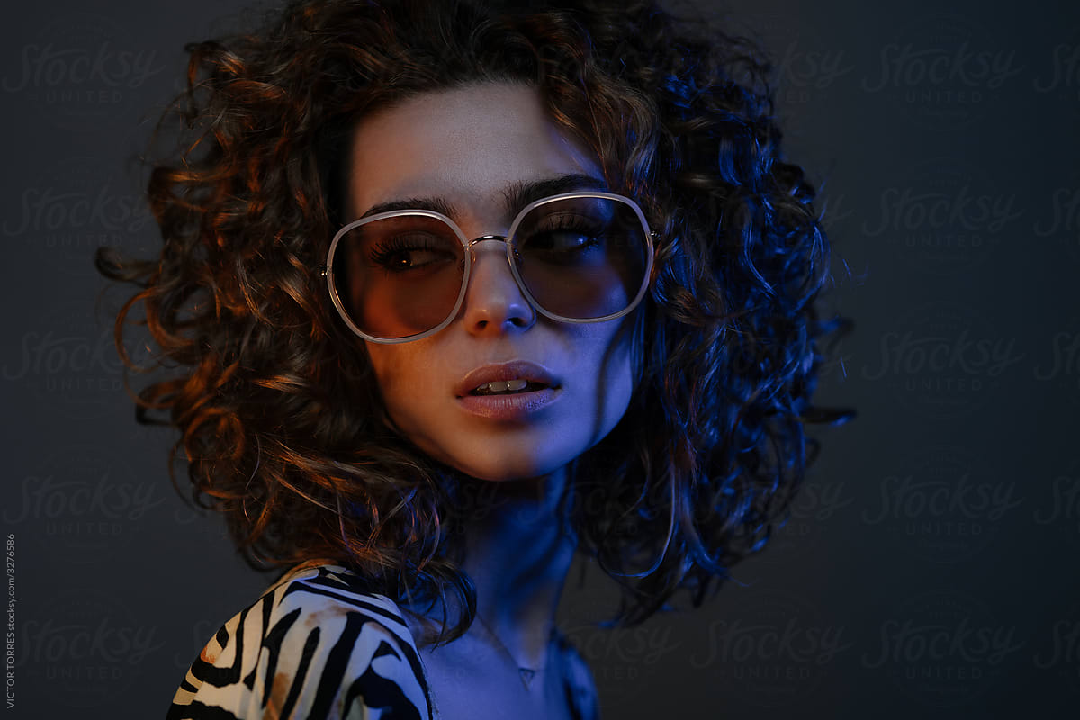 Portrait of young stylish woman in studio