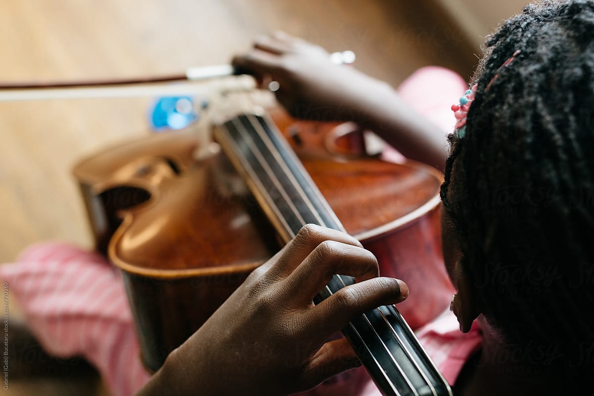 Top view of a black girl playing cello