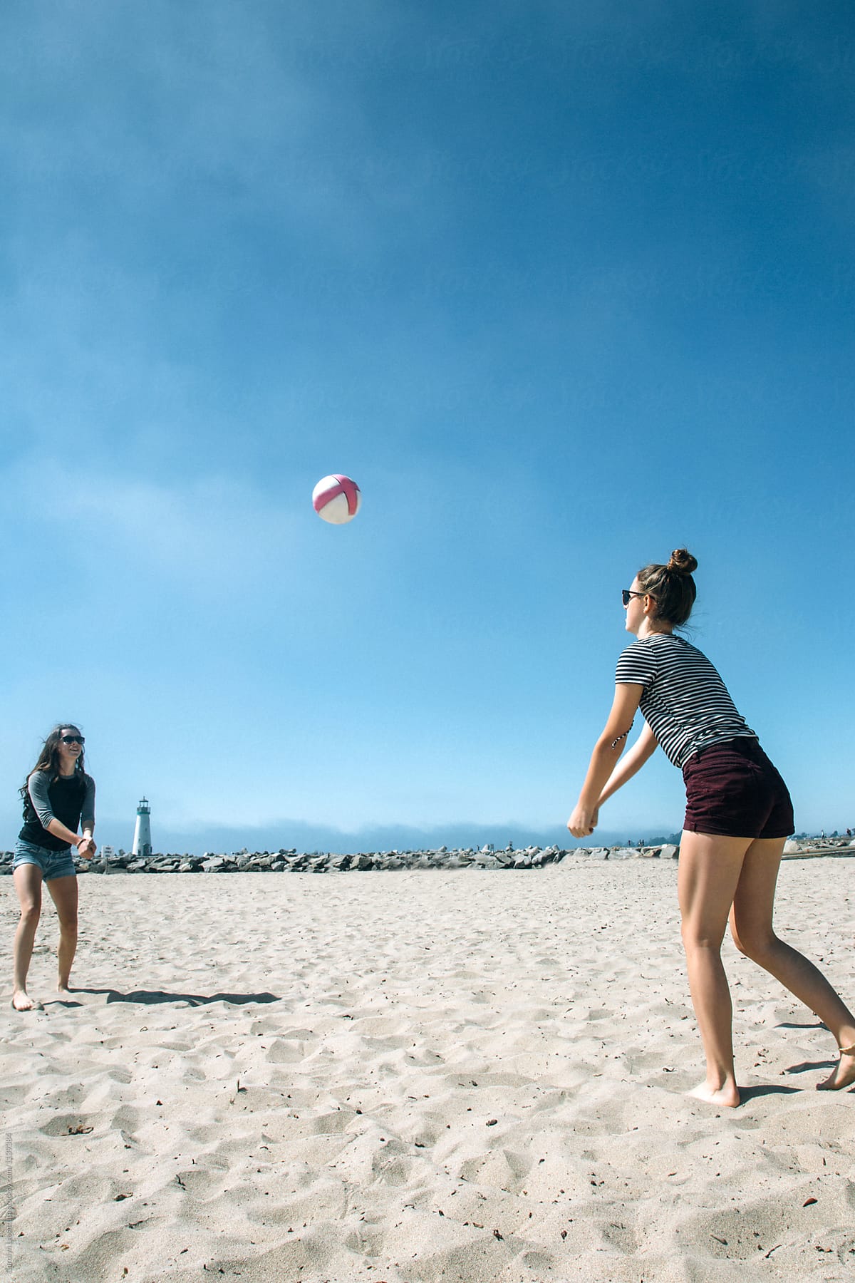 Girls playing volleyball at the beach