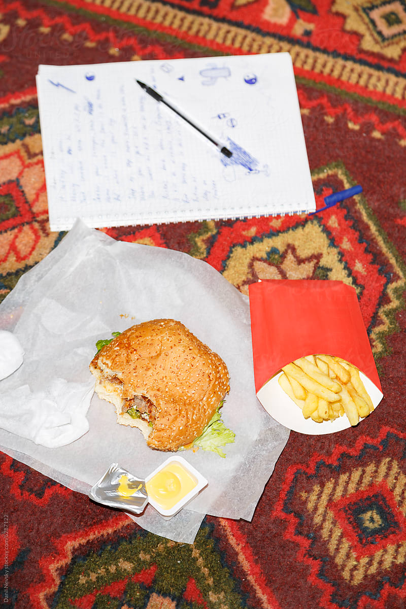 Fast food on carpet with notebook