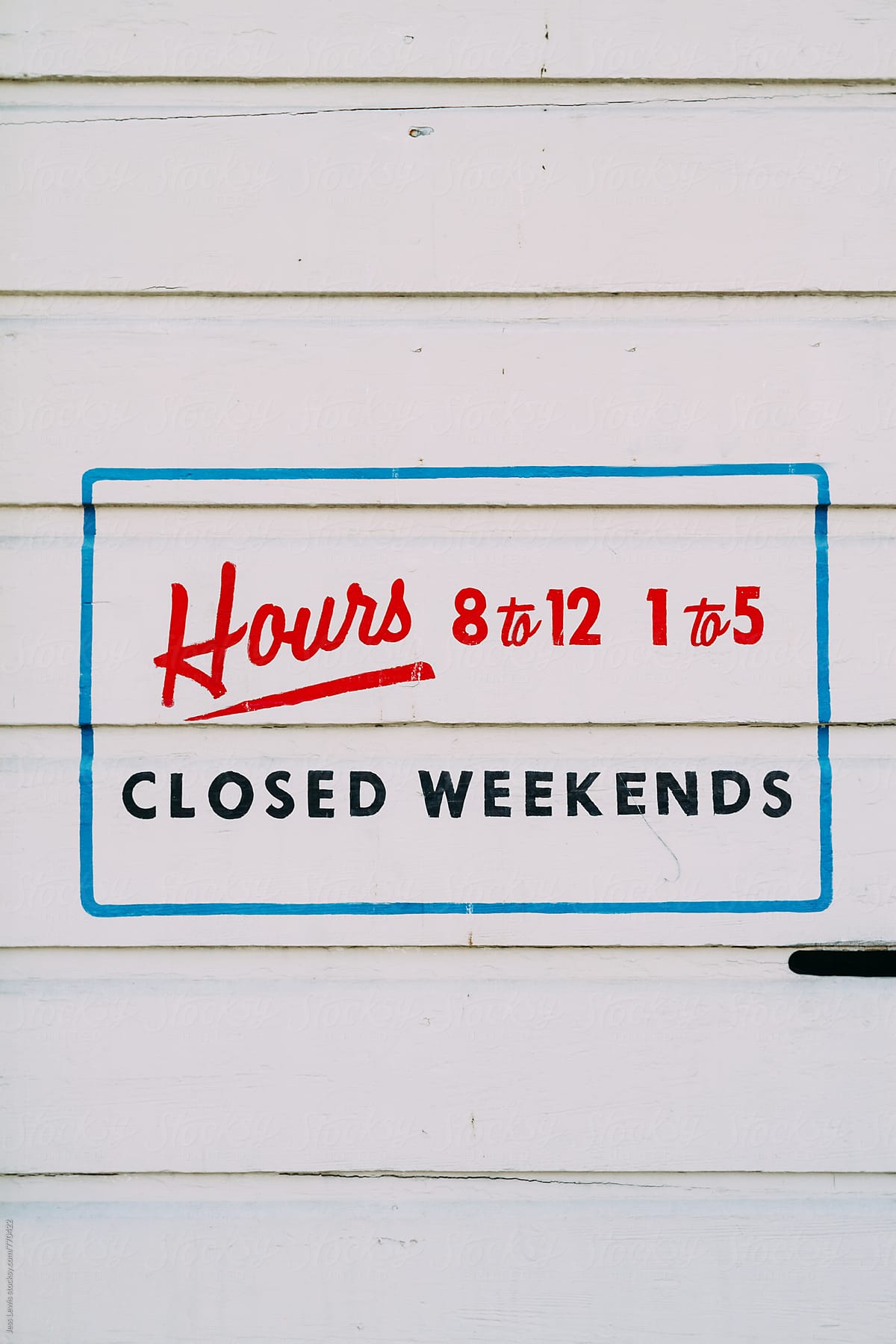 hand lettered sign showing business hours
