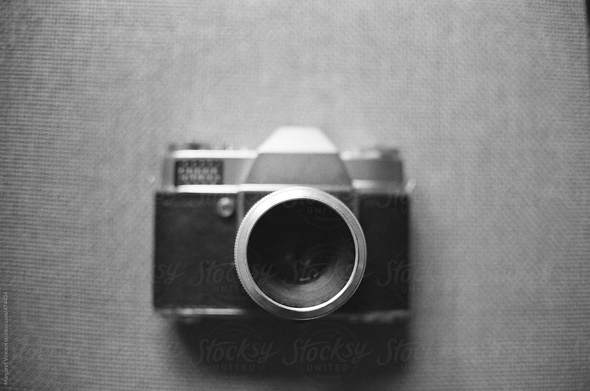 a black and white shot of an old camera