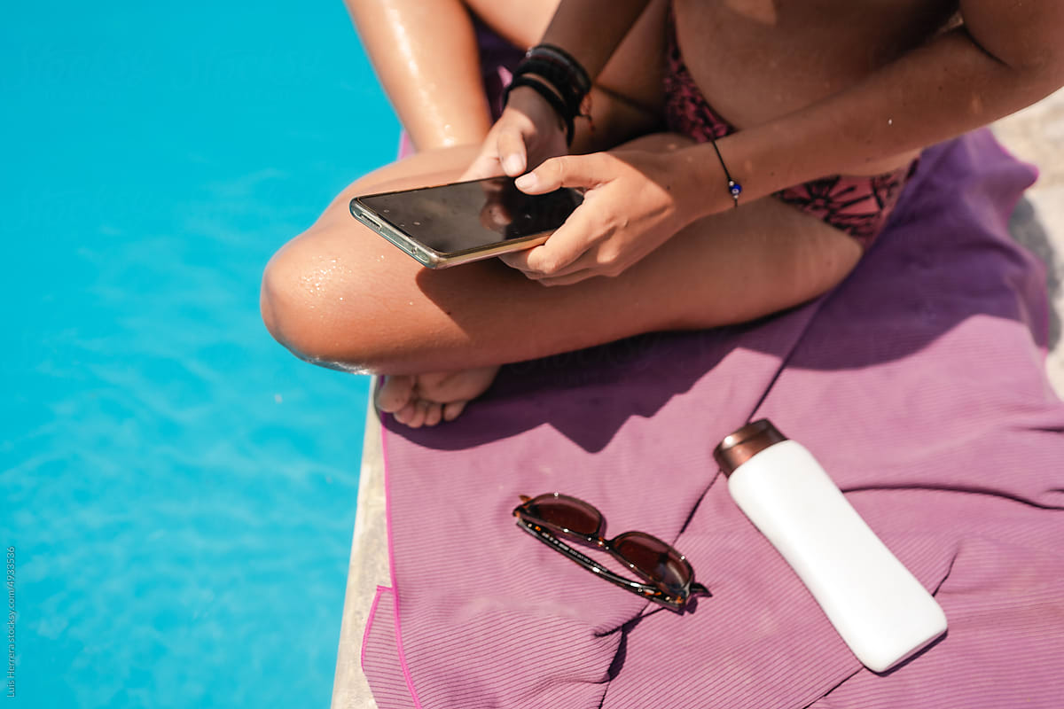 woman at the pool with her phone