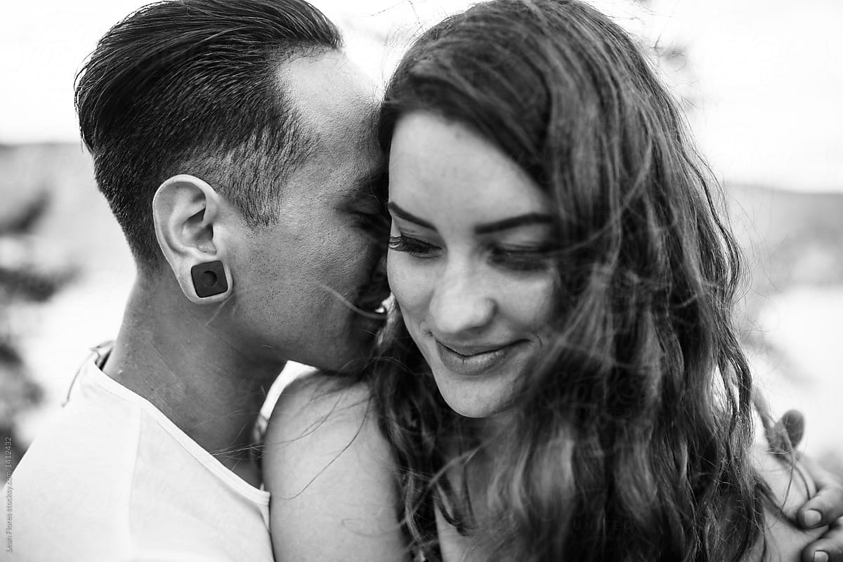 Intimate Photo of Man Whispering in Woman\'s Ear