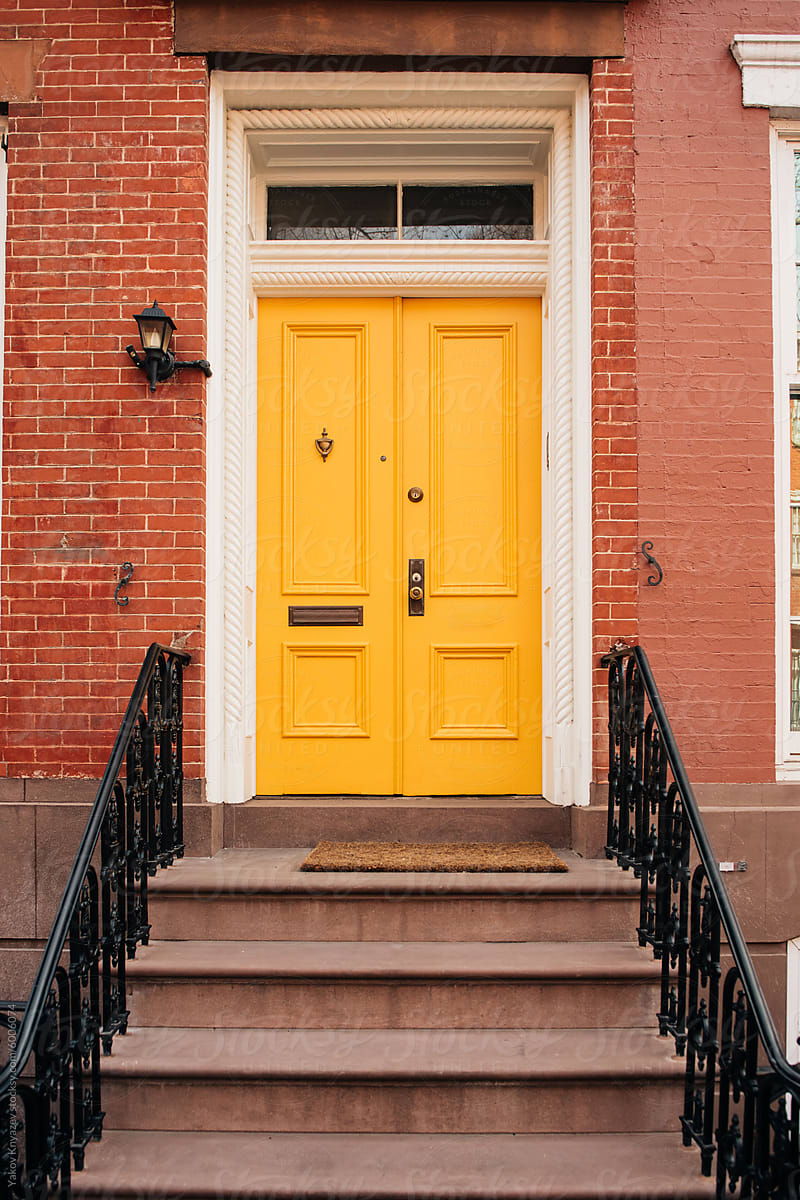 Vibrant Yellow Door on Red Brick Building
