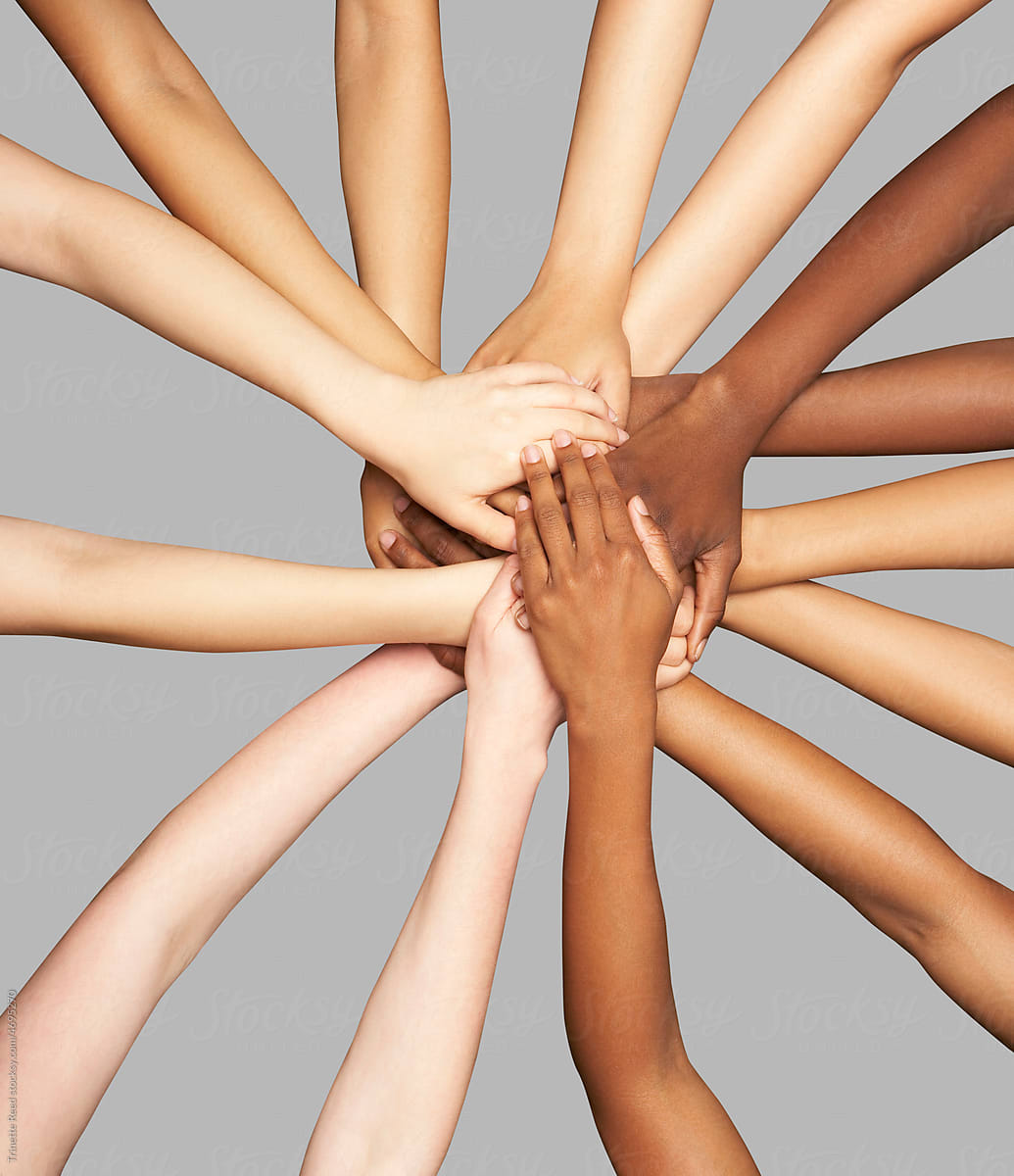 Group of diverse women's hands connected together in inclusion