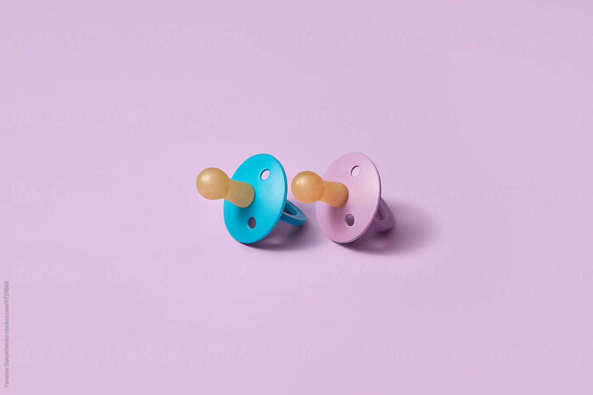 Two blue and pink baby pacifiers.