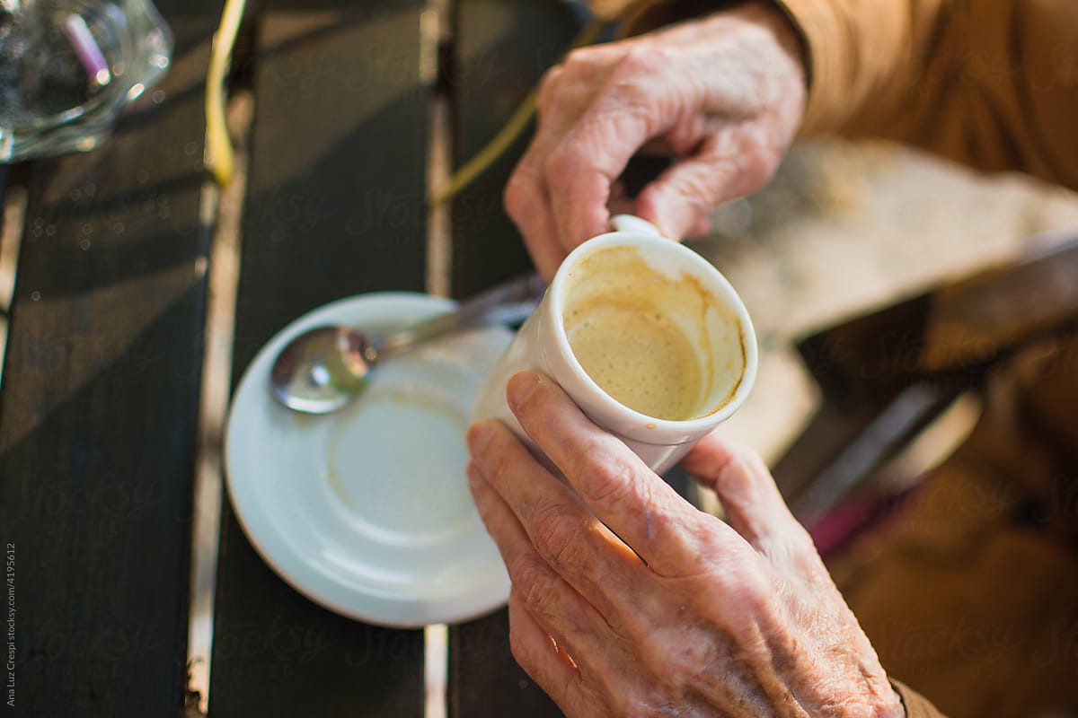 Senior lady's hands holding coffee cup