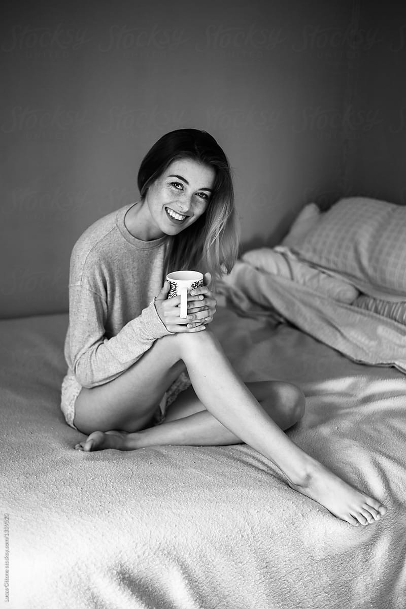 Smiling young woman with a cup of coffee