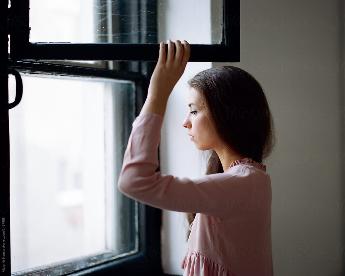 Brunette looking out of window