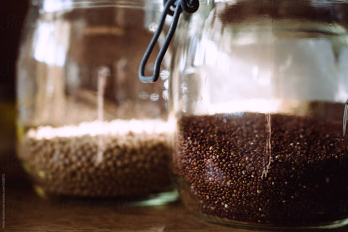 Red quinoa and giant wholewheat couscous in glass jars.