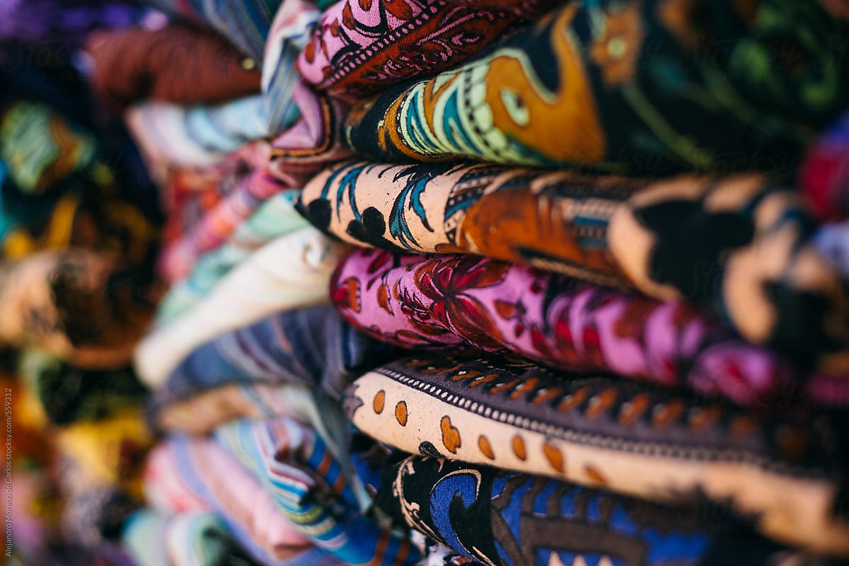 Pile of colourful pieces of fabric on a market. India
