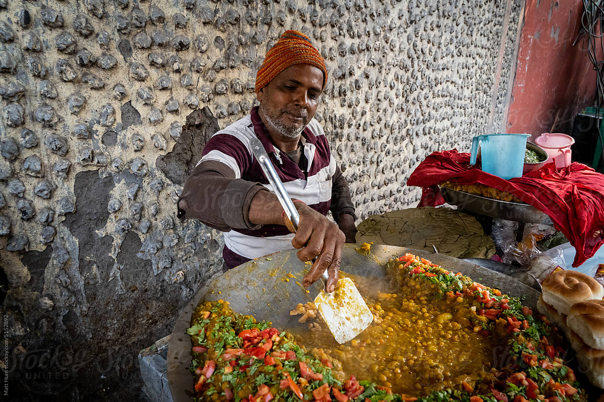 A street vendor cooks vegetarian food on the street in Kolkata, India
