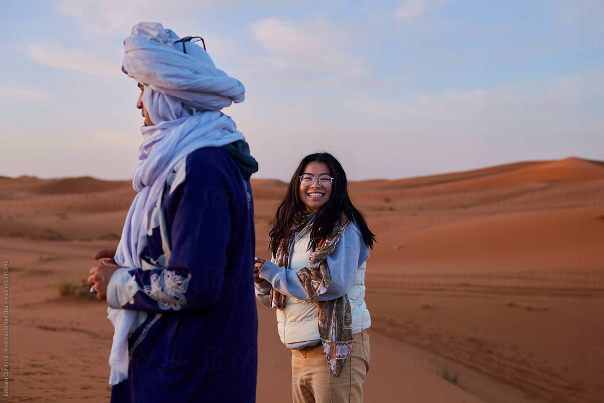 Local guide and smiling tourist enjoy the guided desert expedition.