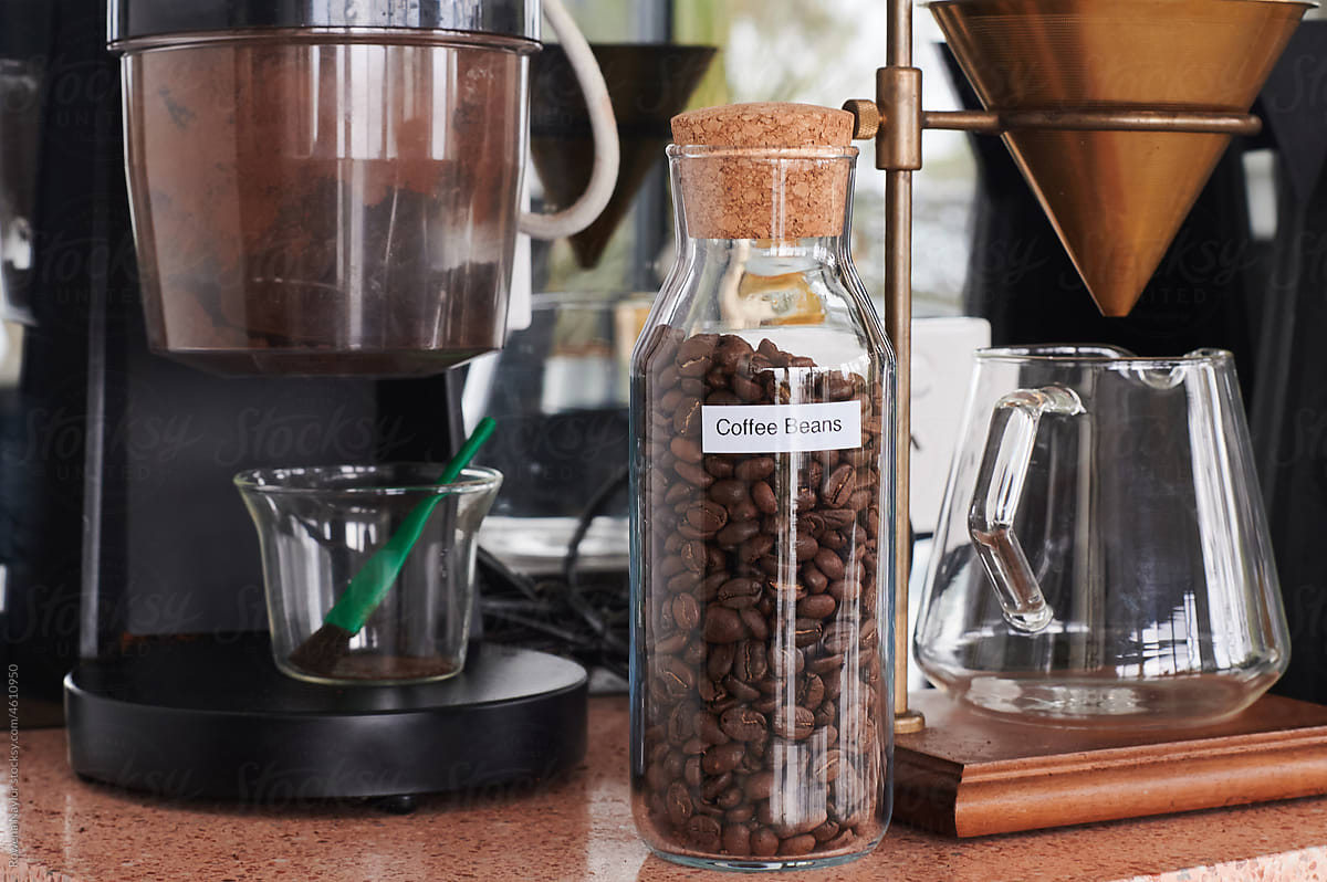 Jar of coffee beans and coffee making equipment