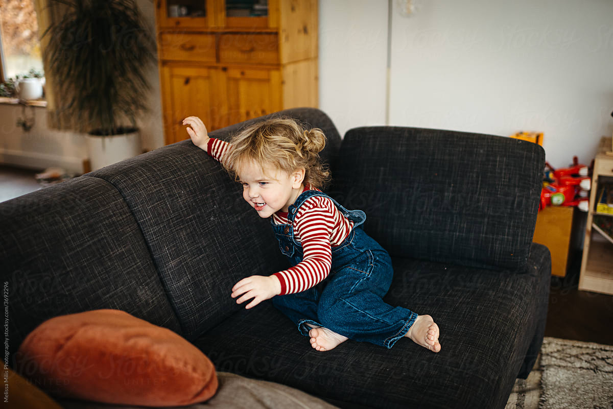 Girl jumping and having fun in the sofa