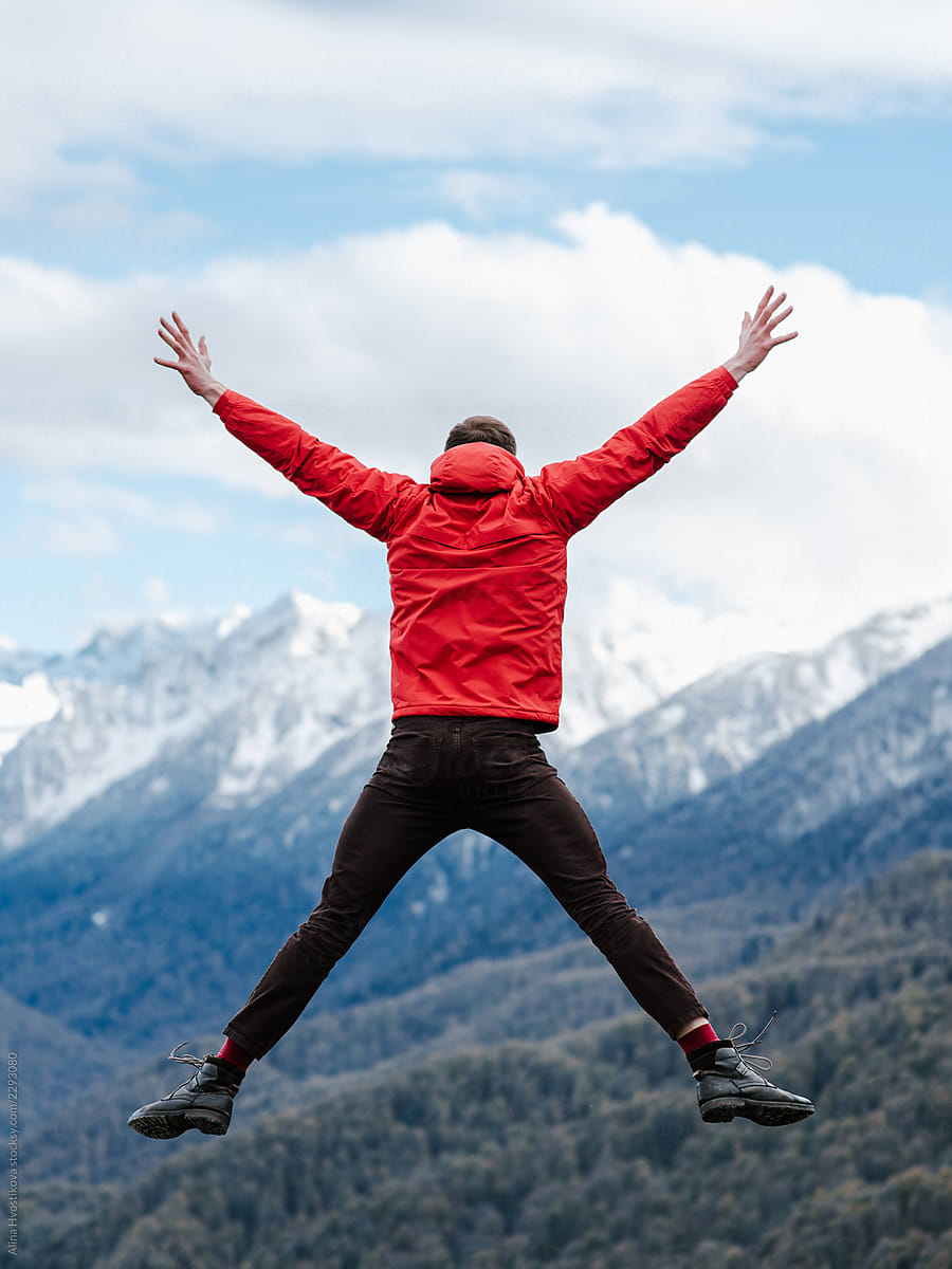 Jumping man on background of mountains