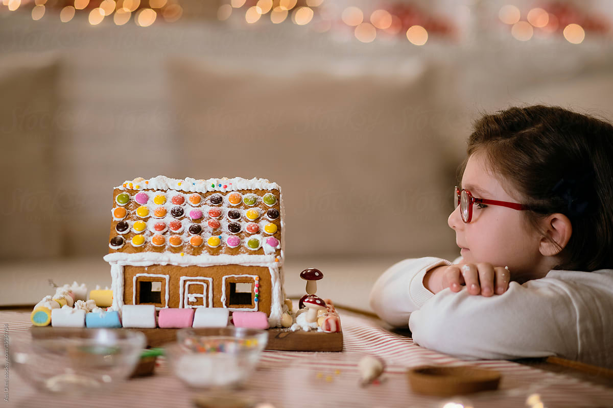 Girl watching her gingerbread house