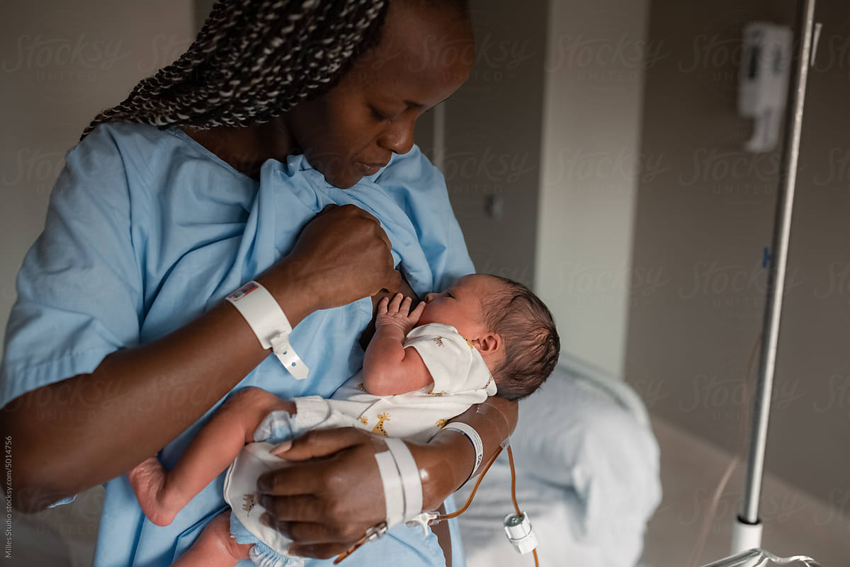 Black mom breastfeeding baby in hospital